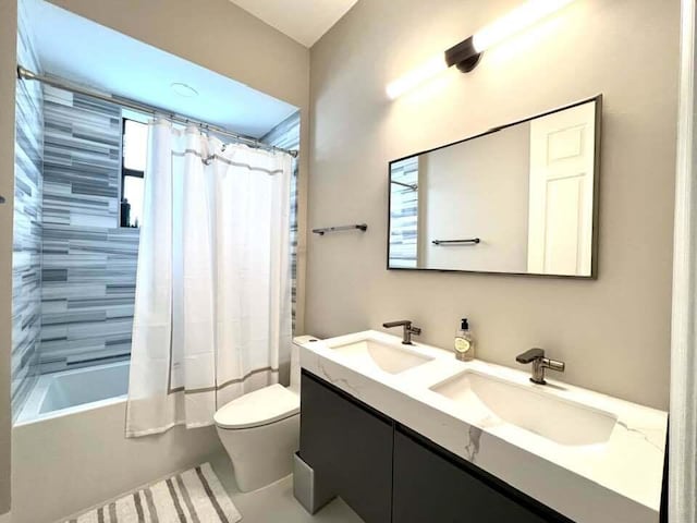 full bath featuring double vanity, a sink, toilet, and shower / bathtub combination with curtain