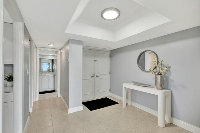 kitchen featuring light tile patterned floors, appliances with stainless steel finishes, tasteful backsplash, and white cabinets