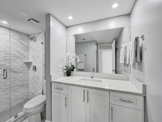 bathroom featuring an enclosed shower, toilet, and vanity