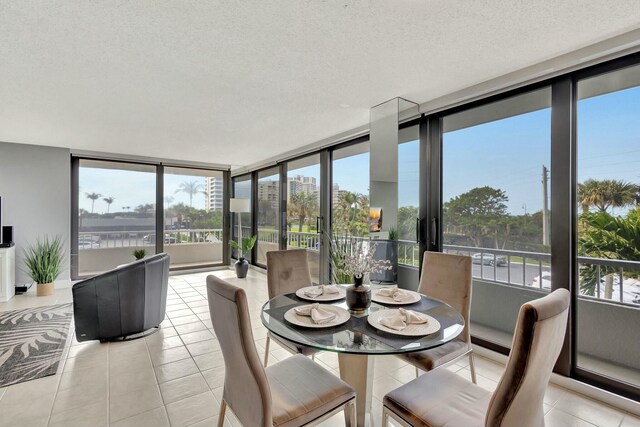 living room with plenty of natural light, a water view, and light tile patterned floors