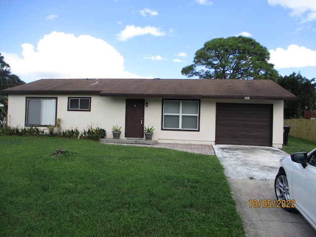 ranch-style home with a front yard and a garage