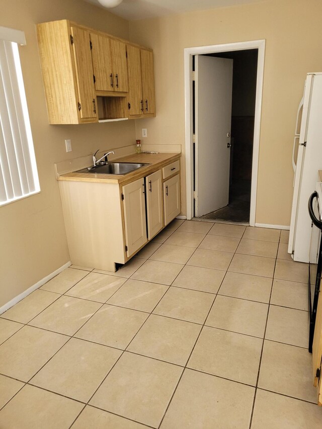 kitchen with white appliances and light tile patterned flooring