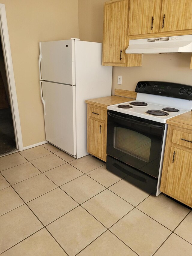 bathroom featuring vanity, tile patterned flooring, and toilet