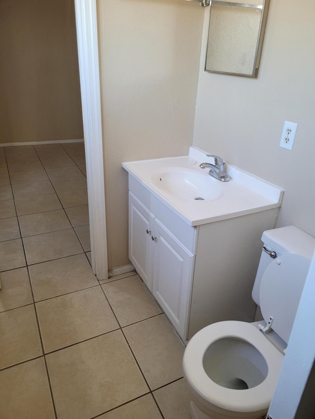 bathroom with vanity, toilet, and tile patterned floors