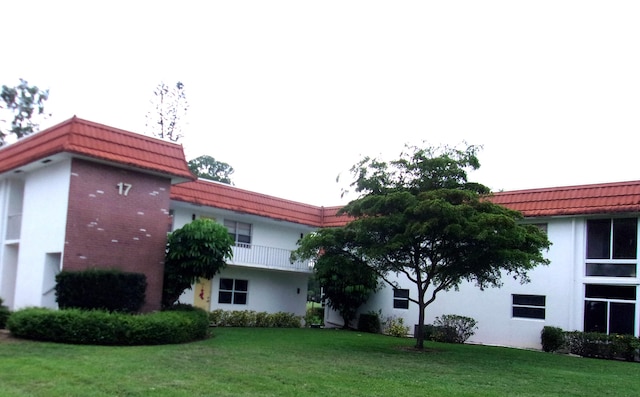 view of side of property with a yard