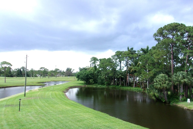 surrounding community featuring a yard and a water view