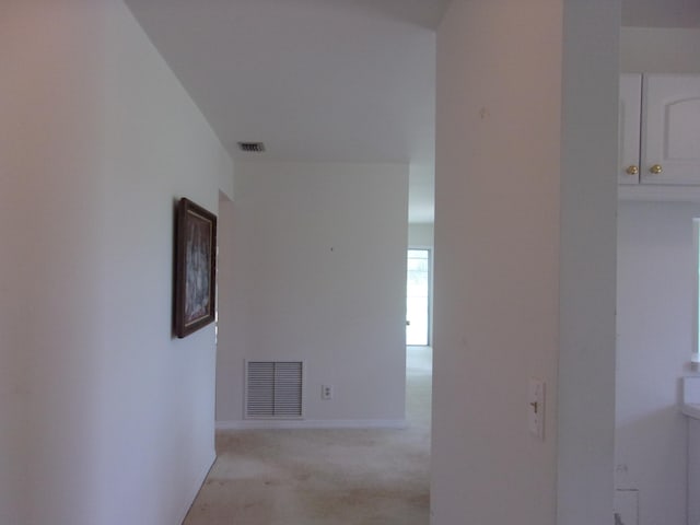 hallway with light colored carpet