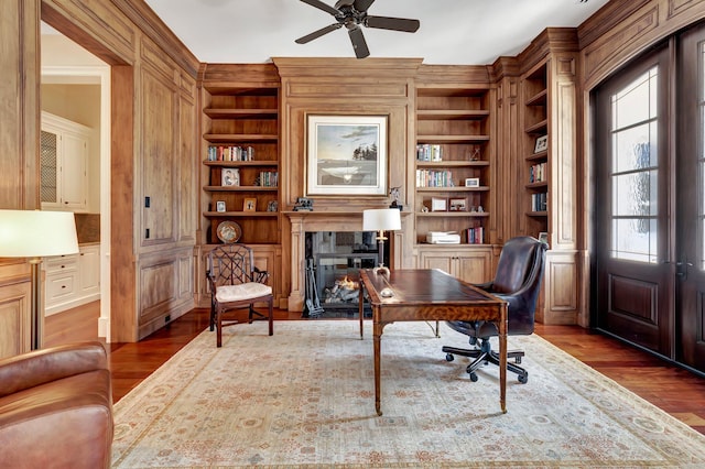 office area featuring built in shelves, hardwood / wood-style flooring, and a wealth of natural light