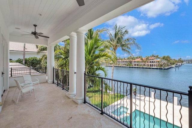 balcony with ceiling fan and a water view