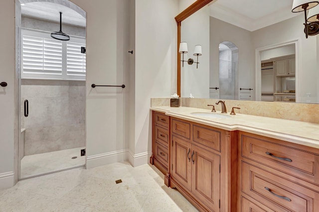 bathroom with an enclosed shower, vanity, tile floors, and ornamental molding