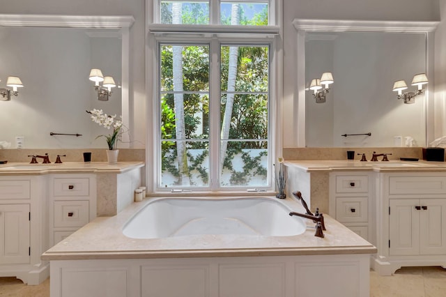 bathroom with dual bowl vanity, tile floors, and a bathing tub