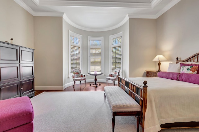 bedroom with a raised ceiling, ornamental molding, and wood-type flooring