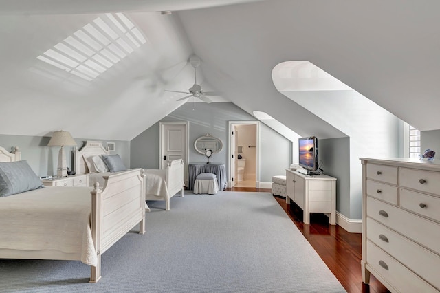 bedroom with vaulted ceiling, dark hardwood / wood-style flooring, connected bathroom, and ceiling fan