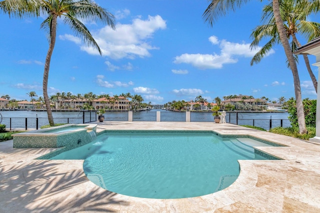 view of swimming pool with an in ground hot tub