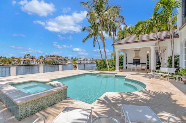 view of pool featuring an in ground hot tub, a patio area, and ceiling fan