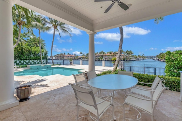 view of swimming pool with a patio, a water view, and ceiling fan