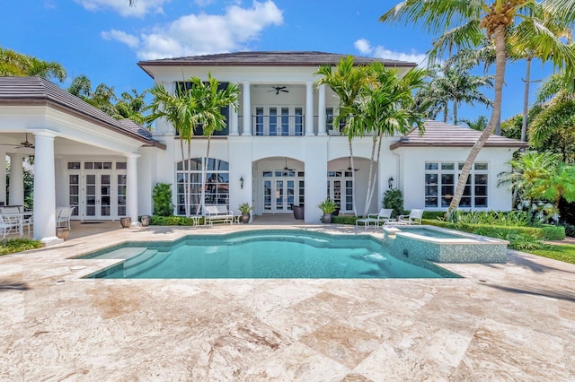 view of pool featuring a patio, an in ground hot tub, ceiling fan, and french doors