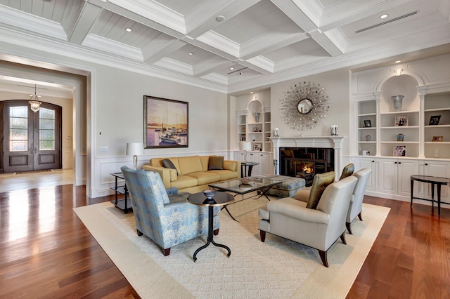 living room with beam ceiling, crown molding, hardwood / wood-style flooring, and coffered ceiling