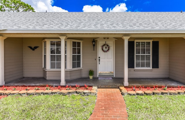 view of exterior entry with a porch