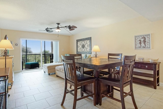 dining area featuring ceiling fan, light tile patterned flooring, and baseboards