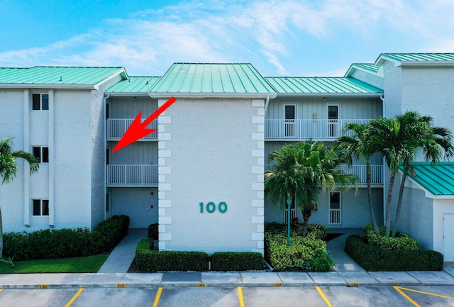 view of building exterior featuring uncovered parking