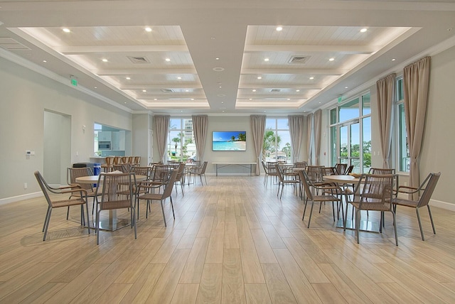 dining space with light wood-type flooring, beam ceiling, and visible vents