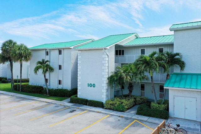 view of building exterior featuring uncovered parking