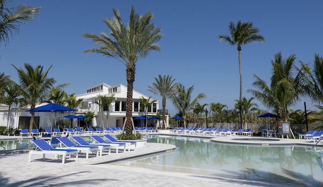 community pool featuring fence and a patio