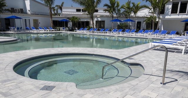 community pool featuring a community hot tub and a patio