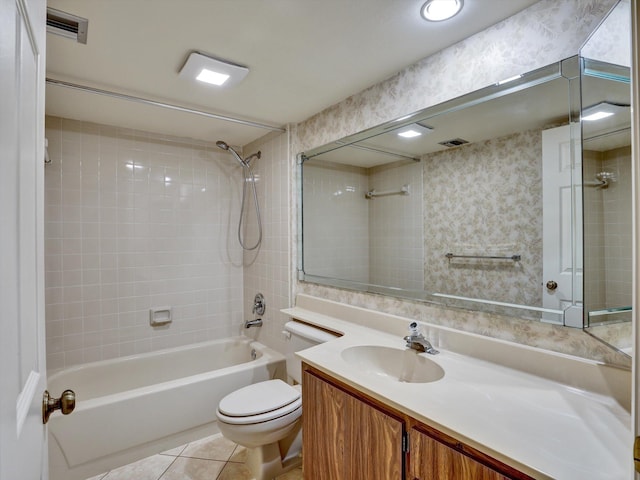 full bathroom featuring tiled shower / bath combo, large vanity, tile floors, and toilet