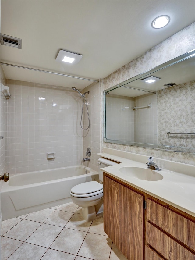 full bathroom featuring vanity, tile floors, toilet, and tiled shower / bath