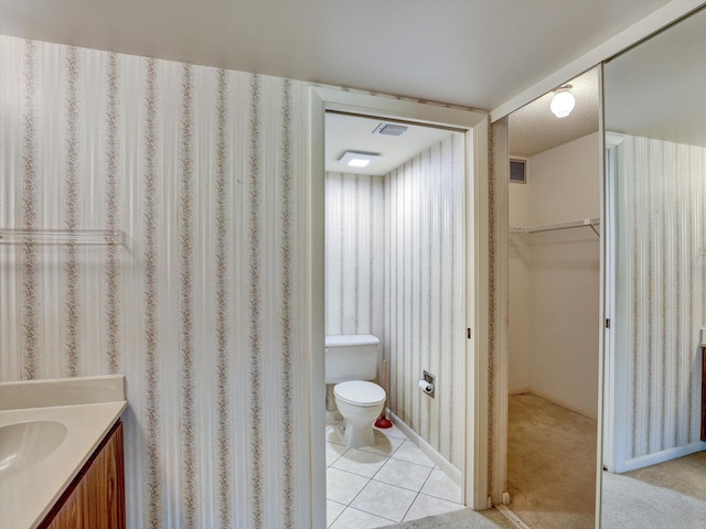 bathroom featuring vanity, tile floors, and toilet