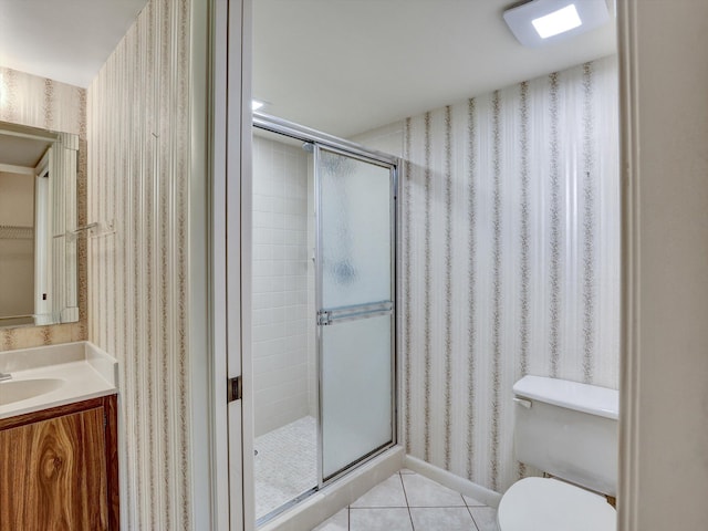 bathroom with a shower with door, toilet, tile flooring, and vanity