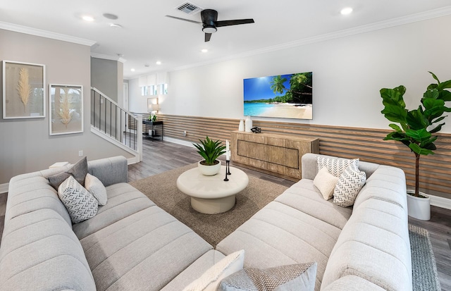 living room with hardwood / wood-style floors, ceiling fan, and ornamental molding