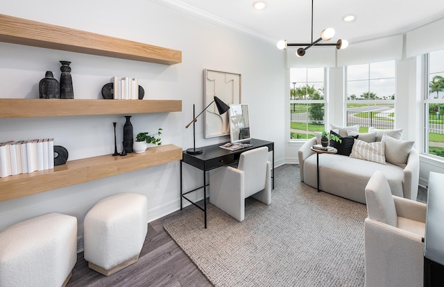 home office featuring an inviting chandelier, ornamental molding, and hardwood / wood-style flooring