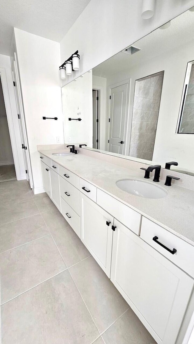 bathroom featuring tile patterned floors and vanity