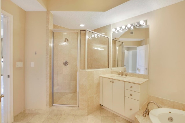 bathroom featuring a textured ceiling, tile patterned floors, vanity, and separate shower and tub