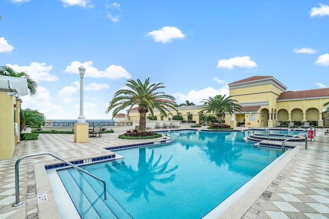 view of pool featuring a jacuzzi and a patio area