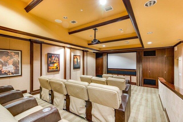 cinema room with beamed ceiling and light colored carpet