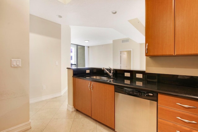 kitchen featuring light tile patterned flooring, sink, and dishwasher