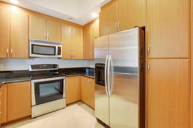 kitchen featuring stainless steel appliances and light tile patterned floors