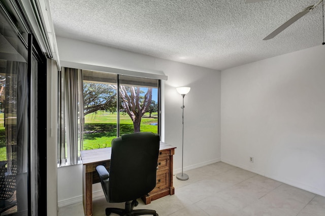 office space featuring ceiling fan, light tile flooring, and a textured ceiling