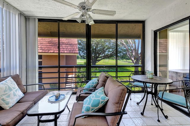 sunroom featuring a healthy amount of sunlight and ceiling fan