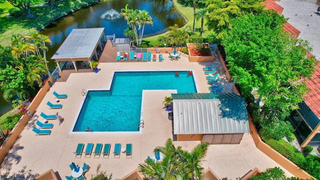 view of swimming pool with a water view and a patio area