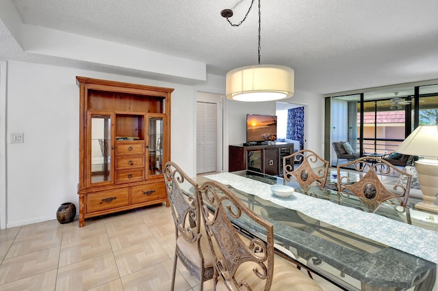 dining area featuring a textured ceiling