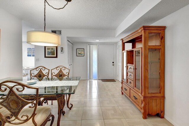 living room featuring light tile floors and a textured ceiling