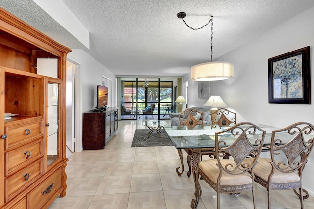 dining area with floor to ceiling windows and a textured ceiling