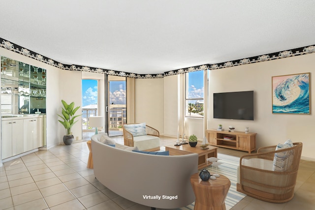 living room with a textured ceiling and light tile flooring