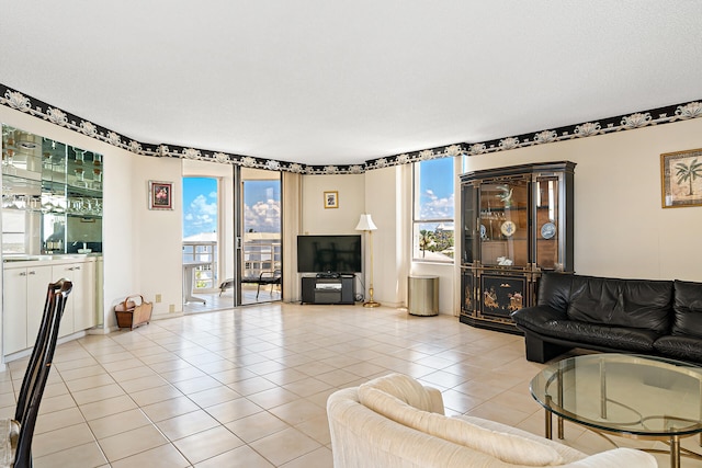 living room featuring a textured ceiling and light tile floors