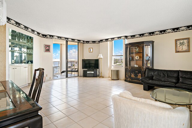 living room featuring tile flooring and a textured ceiling